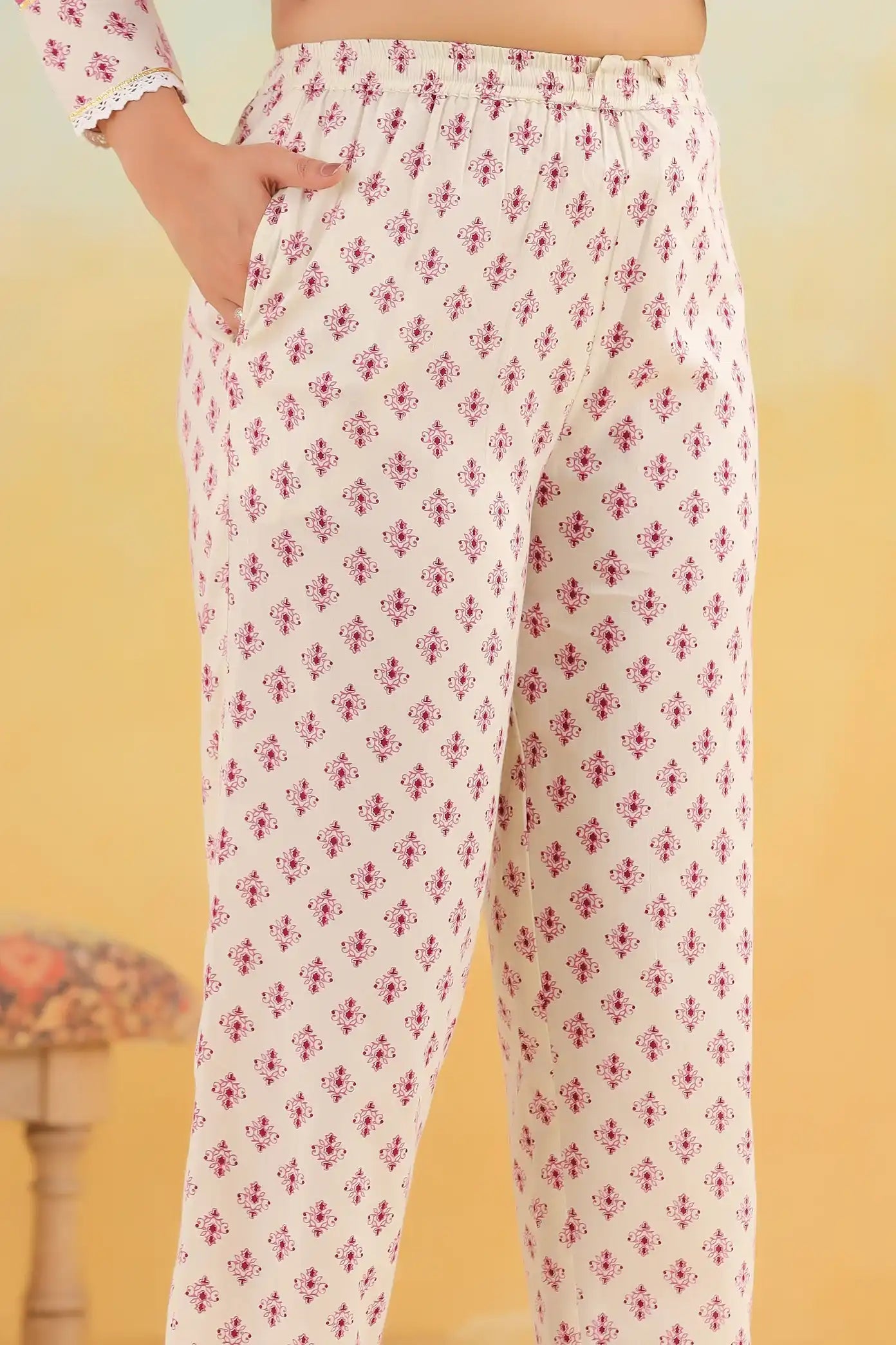 Cream cotton palazzo pants with red floral print, elastic waist, side pockets, perfect for casual or office wear