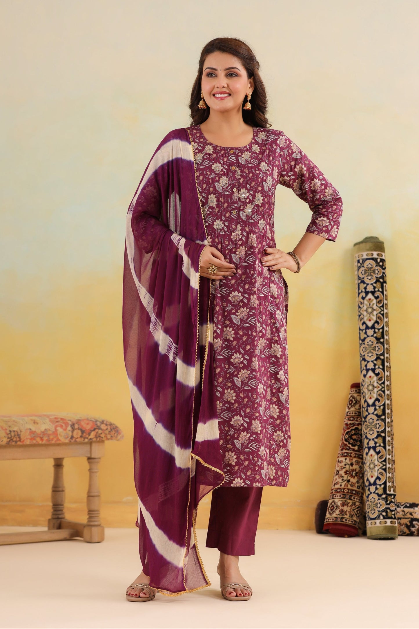 Woman in a floral dress with a matching dupatta against a gradient background