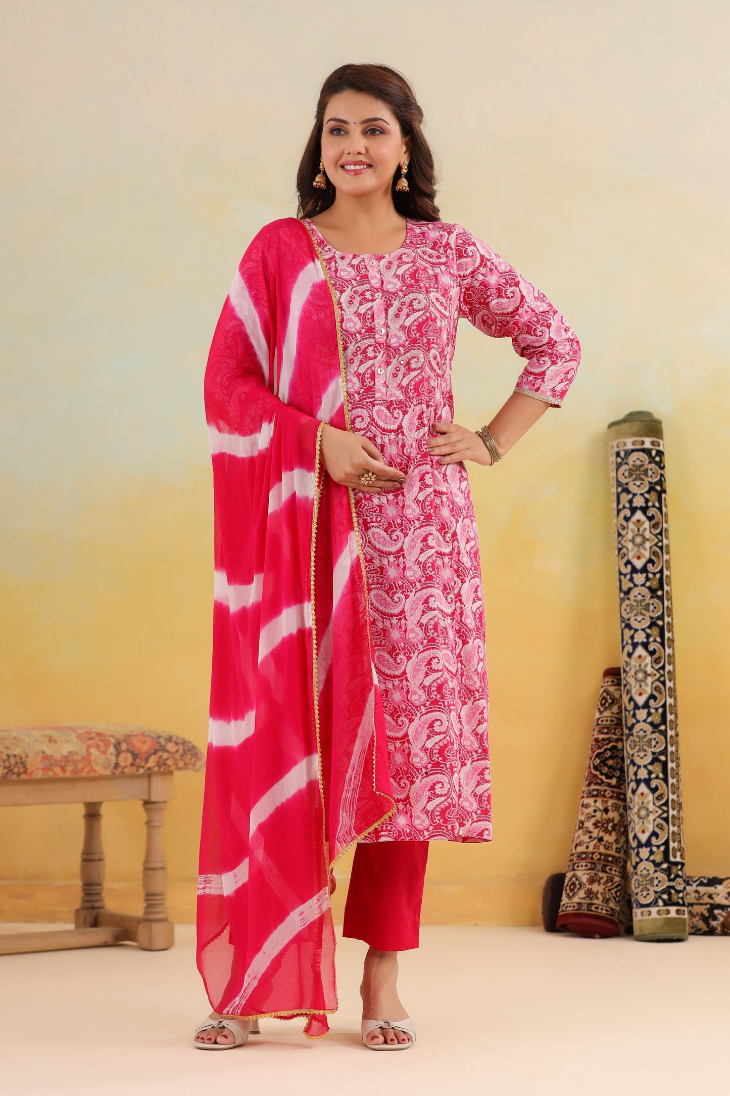 Woman wearing a pink and white traditional outfit with a yellow background
