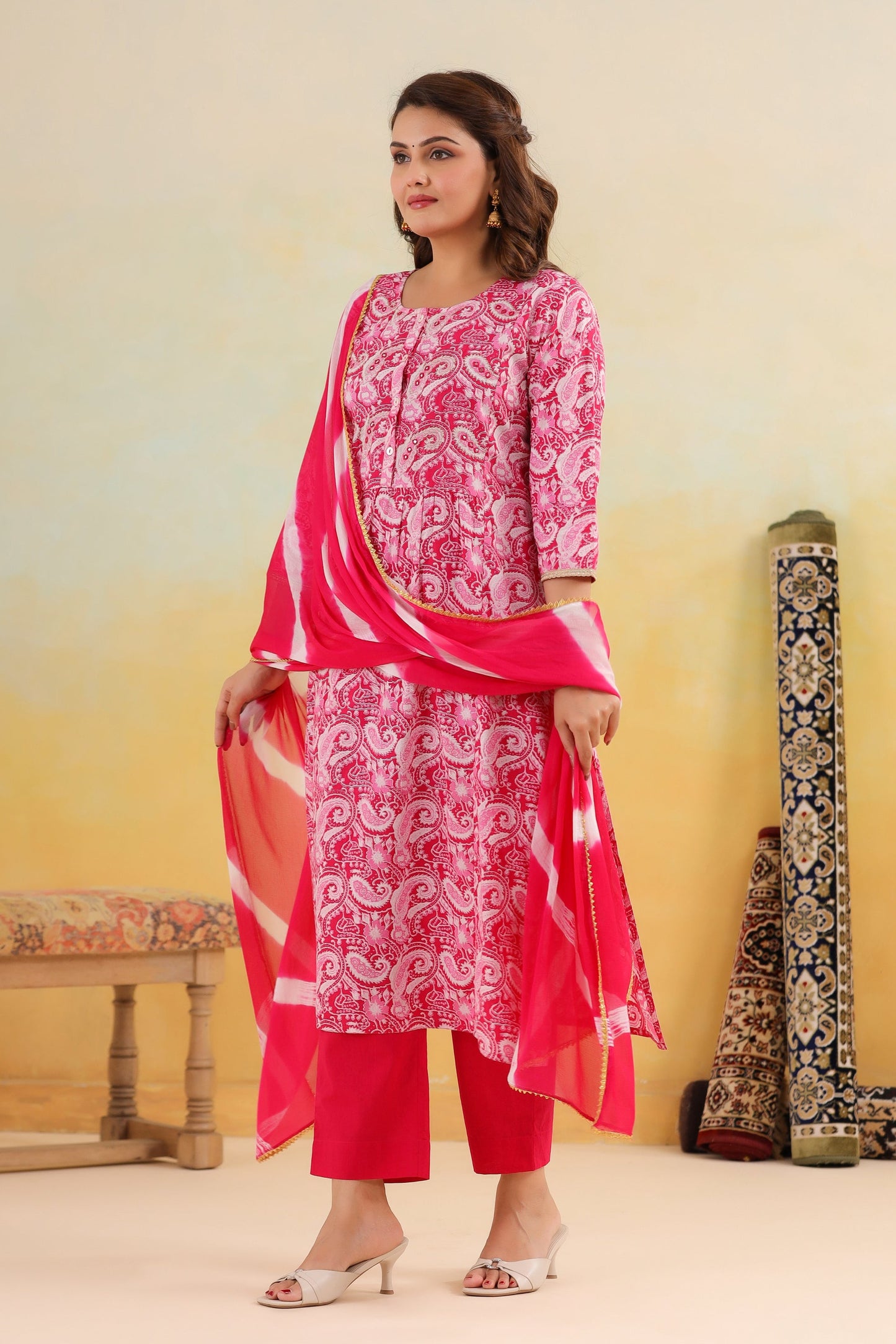 Woman wearing a pink and white traditional outfit with a yellow background
