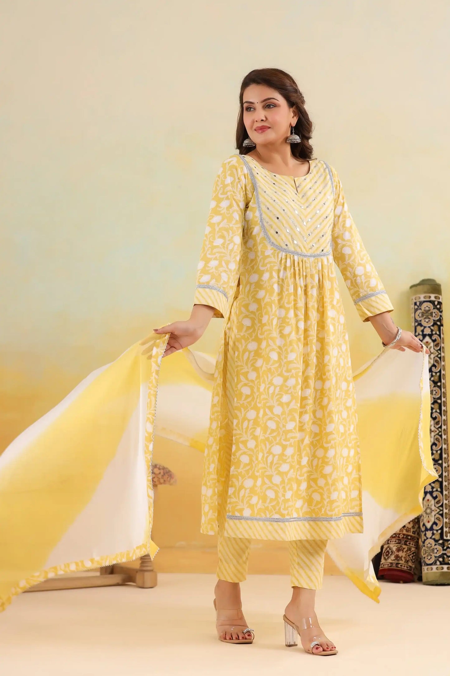 Yellow floral print cotton kurta set with silver embroidery, paired with matching palazzo and dupatta for women