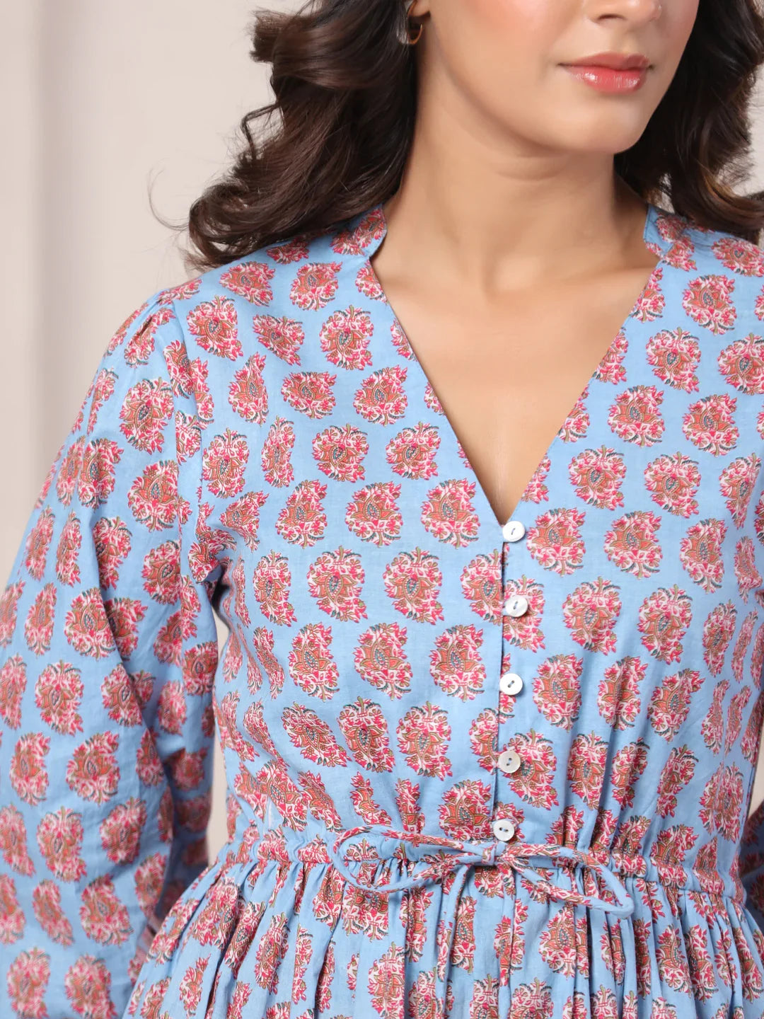 Blue cotton kurta with pink floral print, V-neck, buttons, and tie waist for women