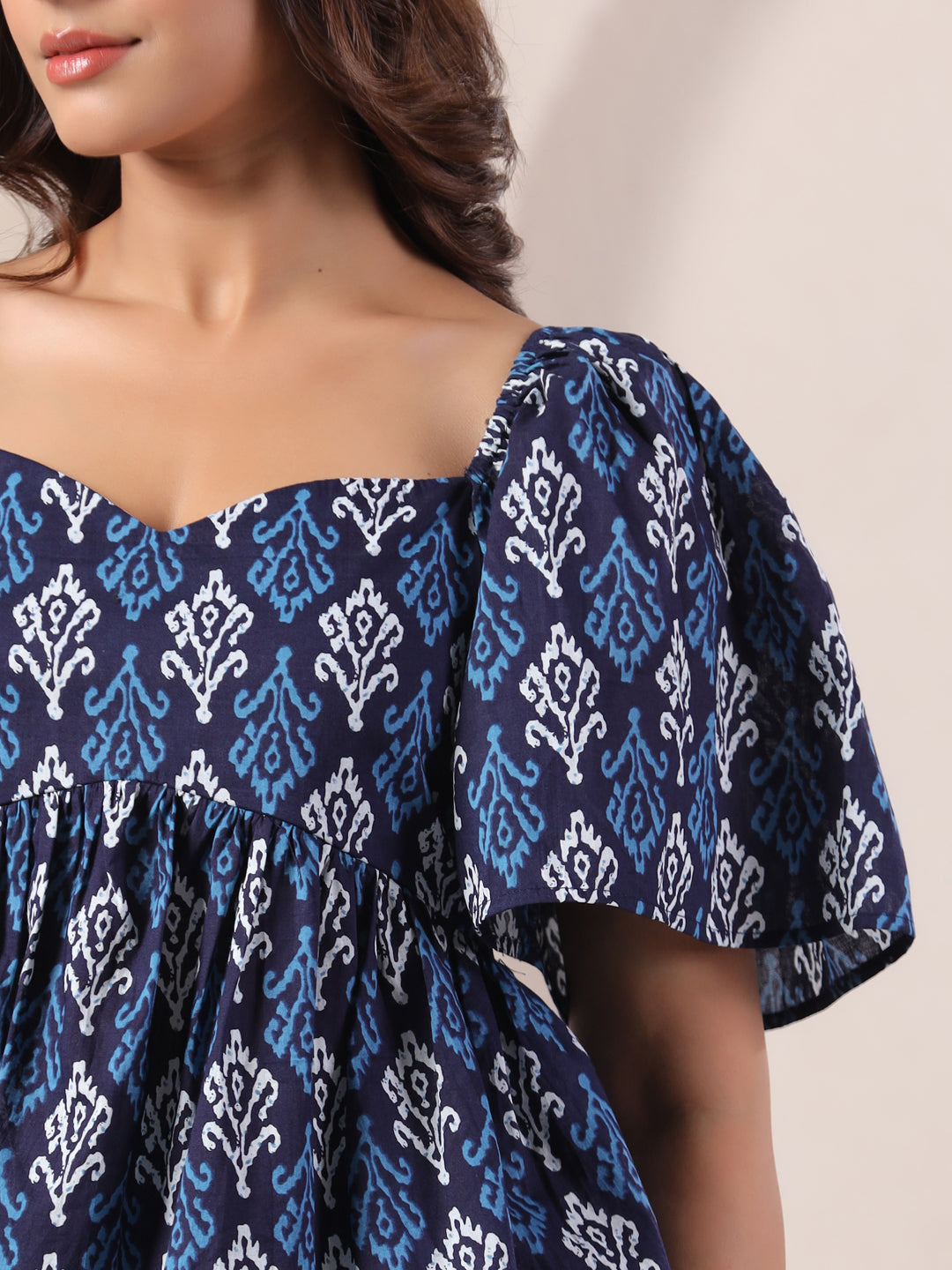 Navy blue cotton kurta with white and light blue ikat print, off-shoulder design, puff sleeves