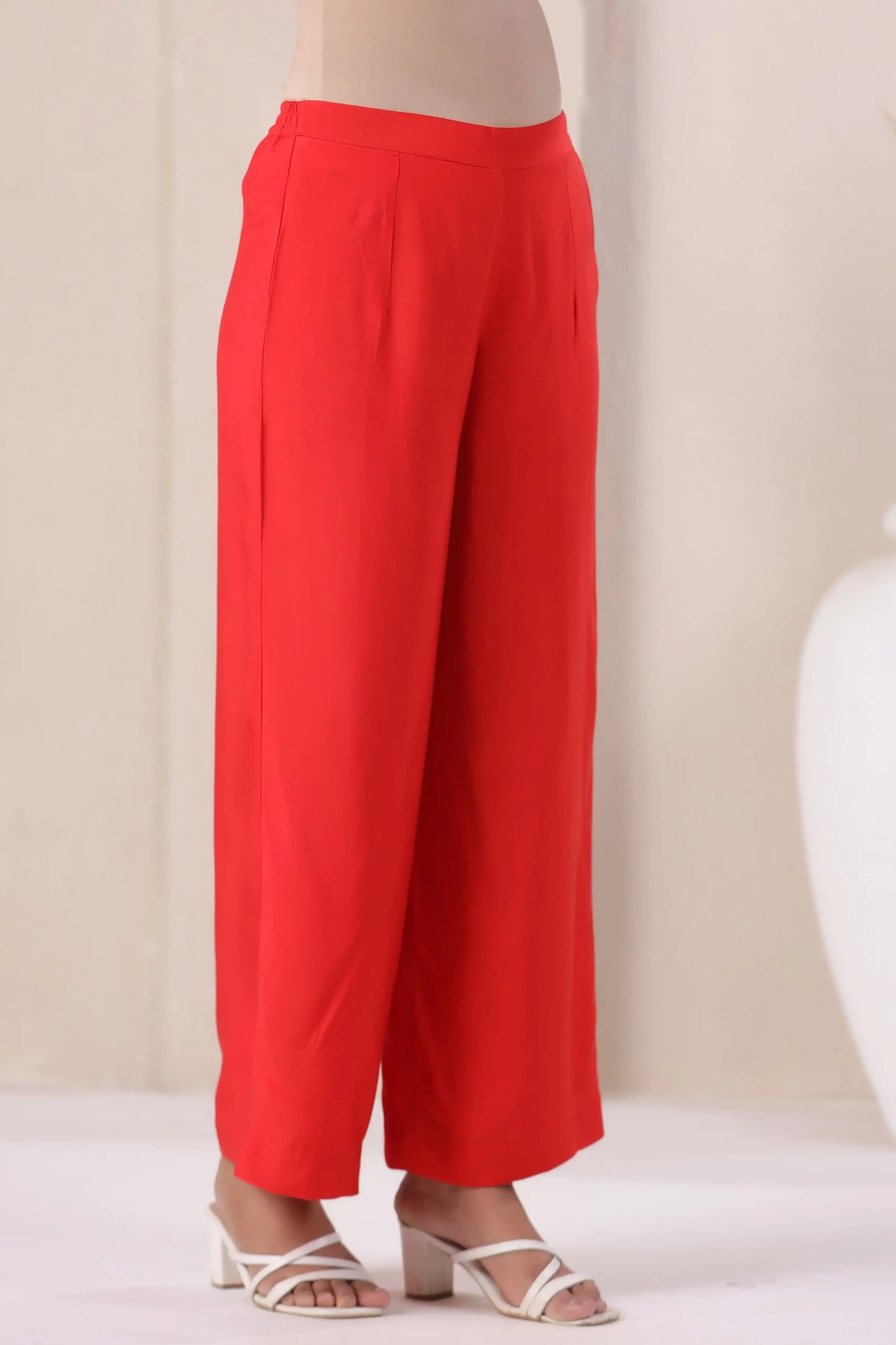 Vibrant red wide-leg cotton pants paired with white heels for elegant daily wear
