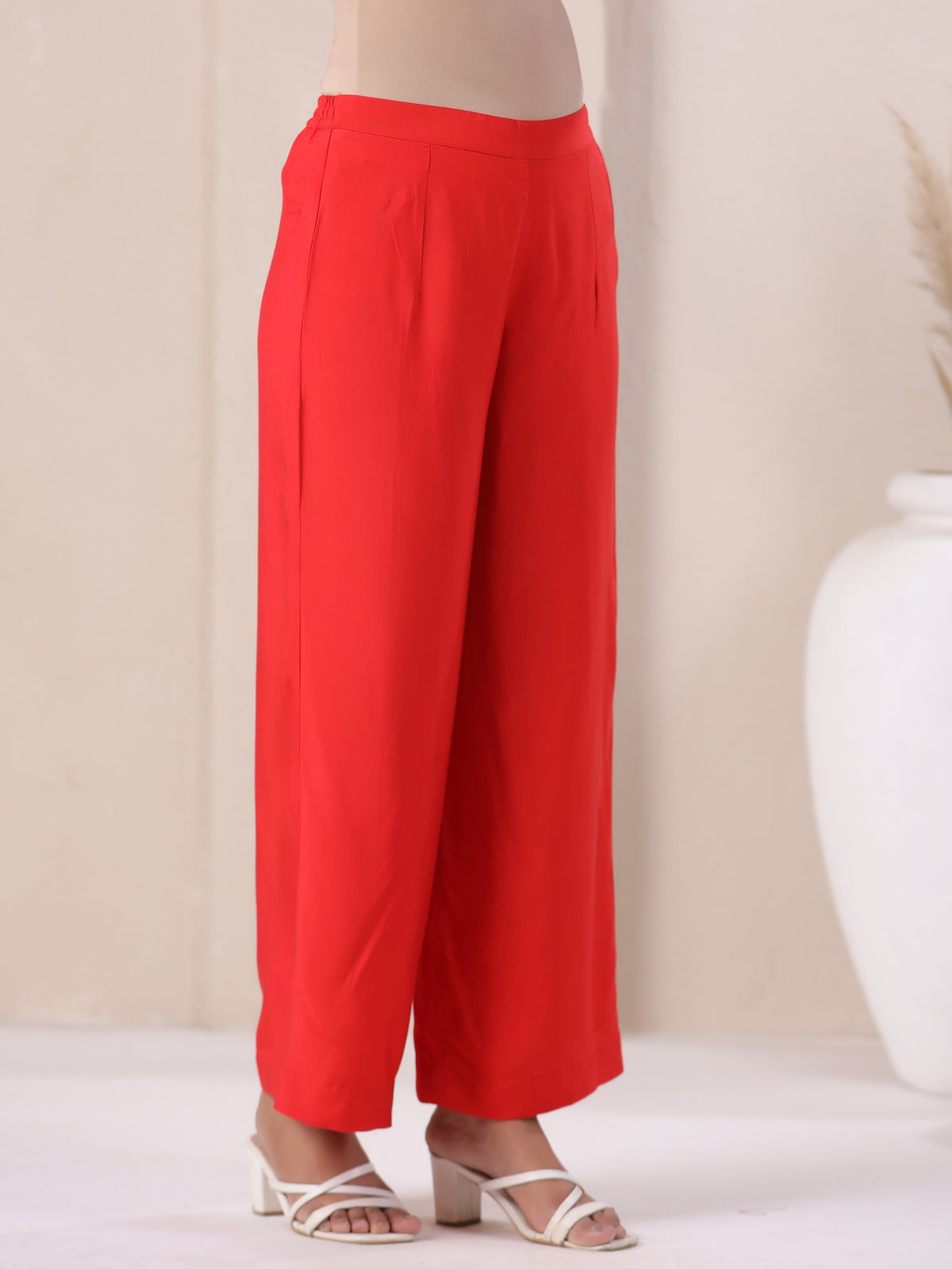 Vibrant red wide-leg cotton pants paired with white heels for elegant daily wear