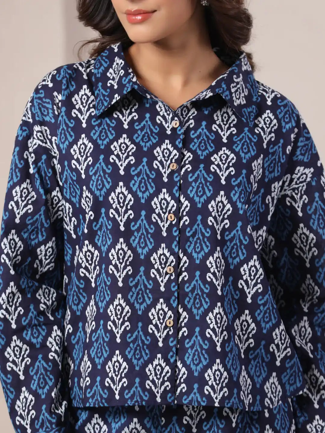 Navy blue cotton kurta with white and light blue ikat print, button front, for women's daily or festive wear
