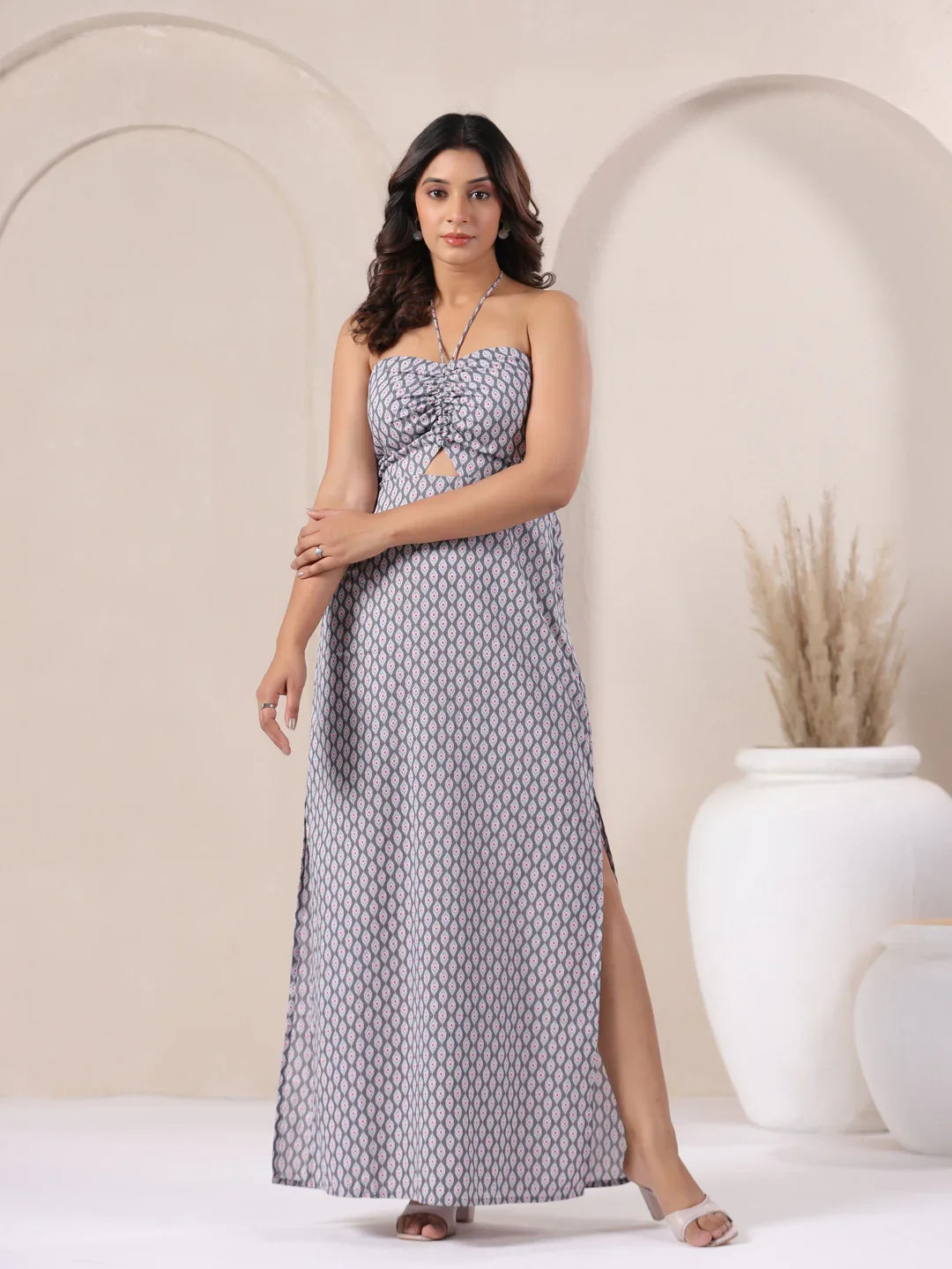 Woman in grey patterned strapless maxi dress with side slit, elegant for daily or festive wear