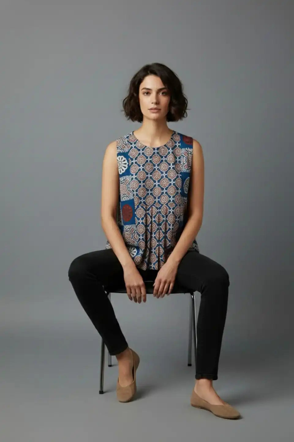 Woman wearing sleeveless printed cotton top with black pants, stylish daily wear outfit