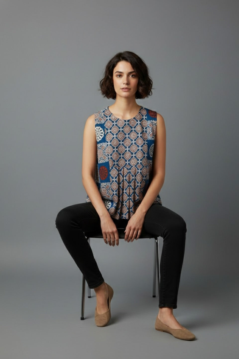 Woman wearing sleeveless printed cotton top with black pants, stylish daily wear outfit