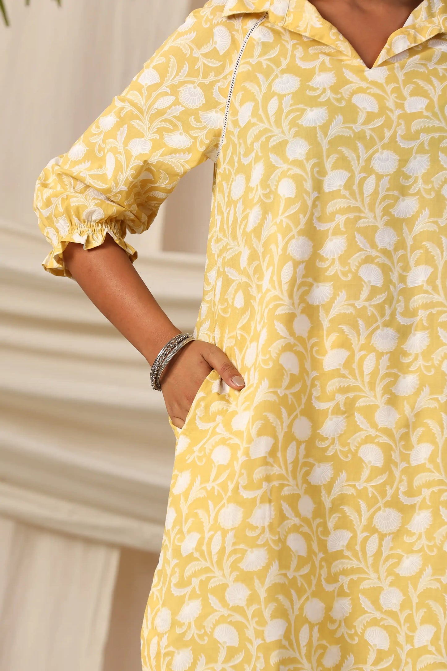 Yellow cotton kurta with white floral print, puff sleeves, and side pocket for women