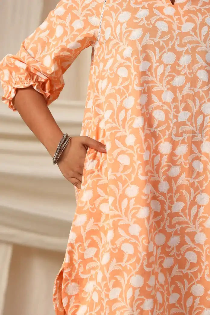 Peach cotton kurta with white floral print, ruffled sleeves, and side pocket for women