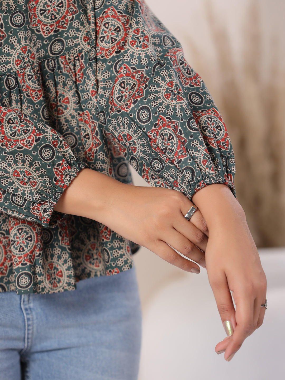 Woman wearing printed cotton kurta with puff sleeves, paired with jeans for casual daily wear