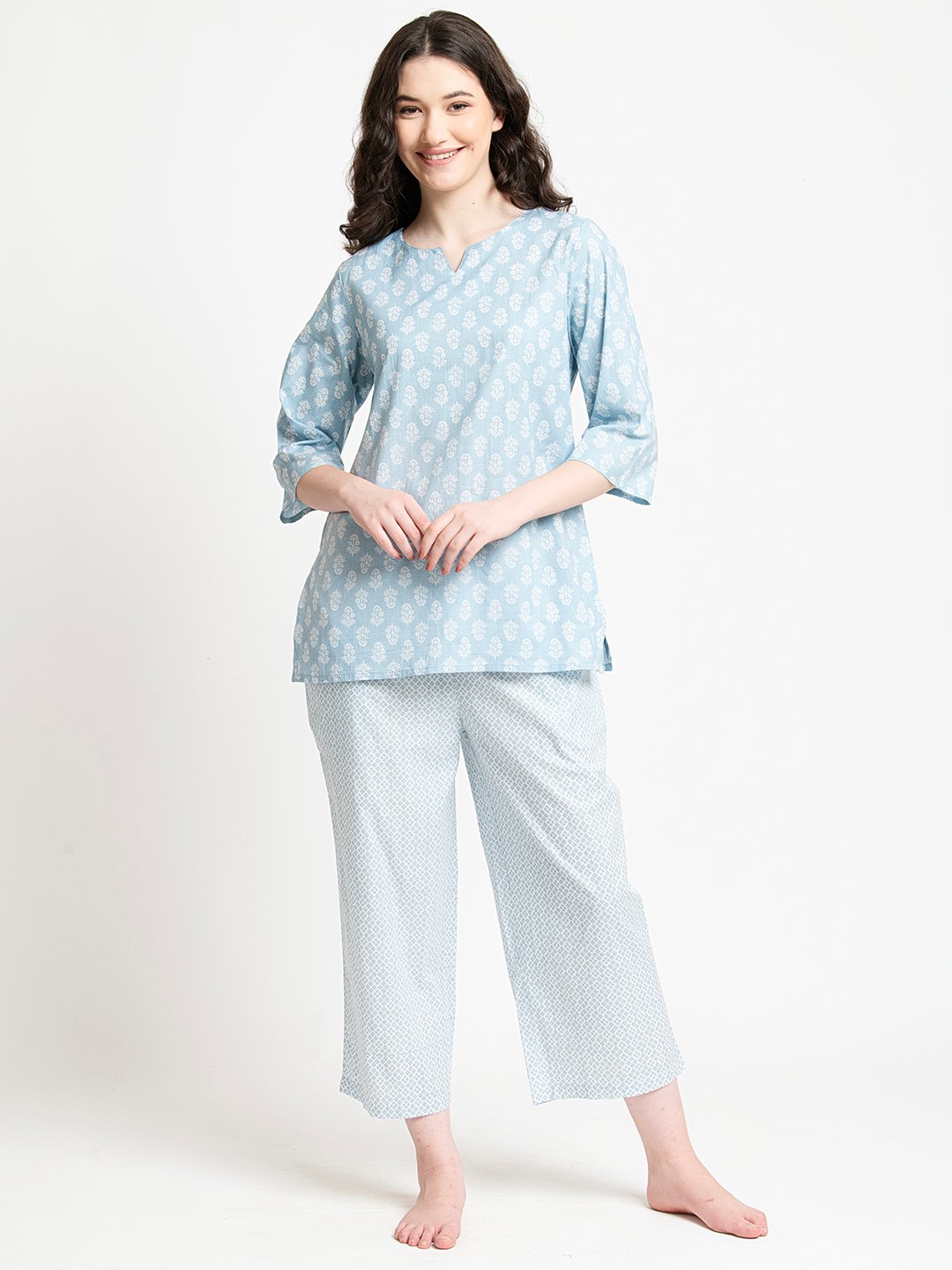 Light blue cotton kurta set with white floral print, relaxed fit, and cropped pants for women