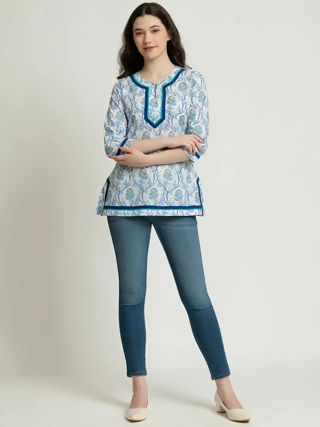 Blue floral print cotton kurta with contrast trim, paired with jeans for casual wear