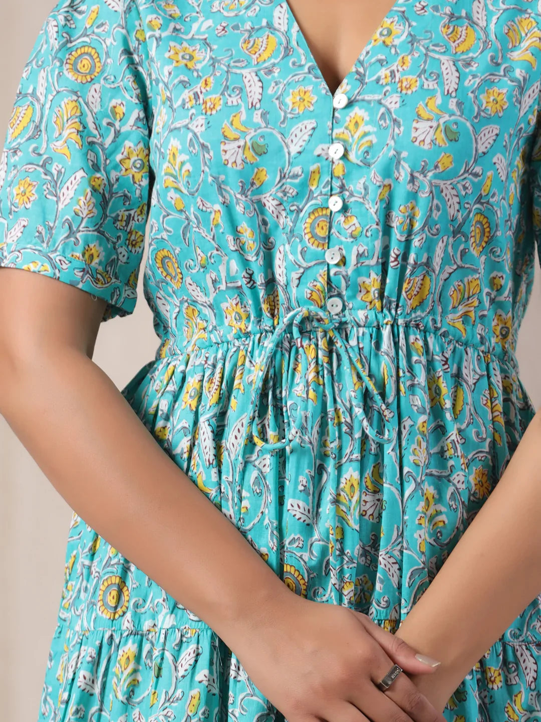 Turquoise floral print cotton kurta with button front and drawstring waist, perfect for daily wear or celebrations.