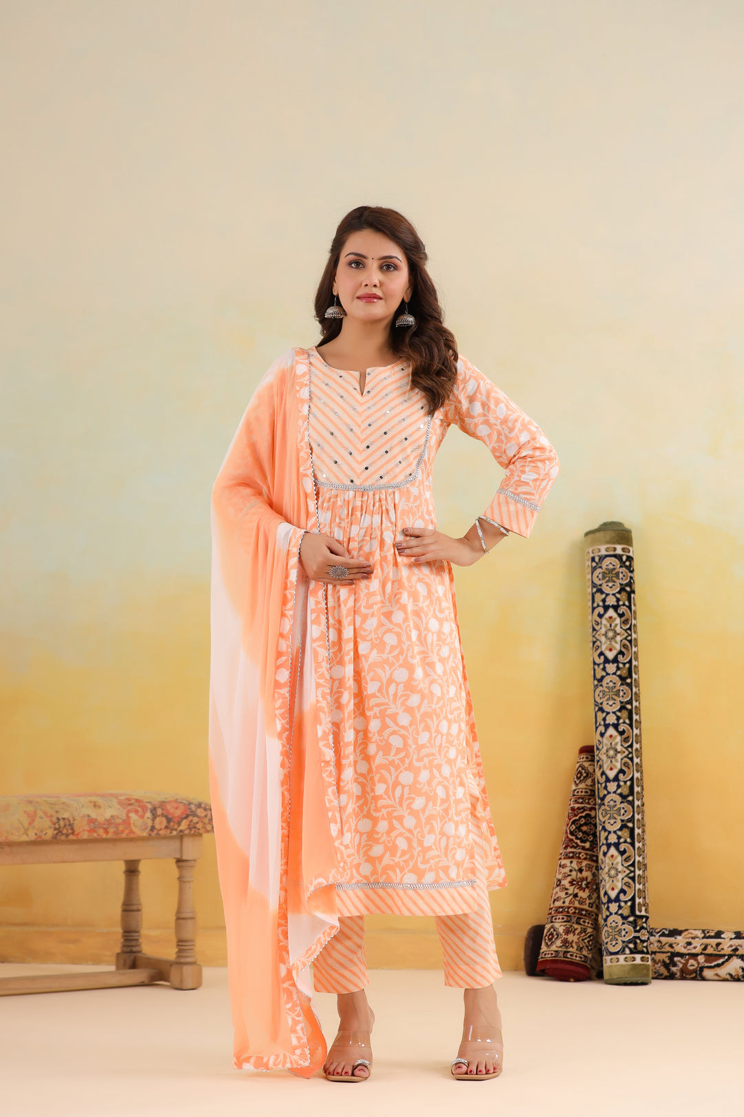 Peach cotton kurta set with white floral print, silver embroidery, and matching dupatta for women
