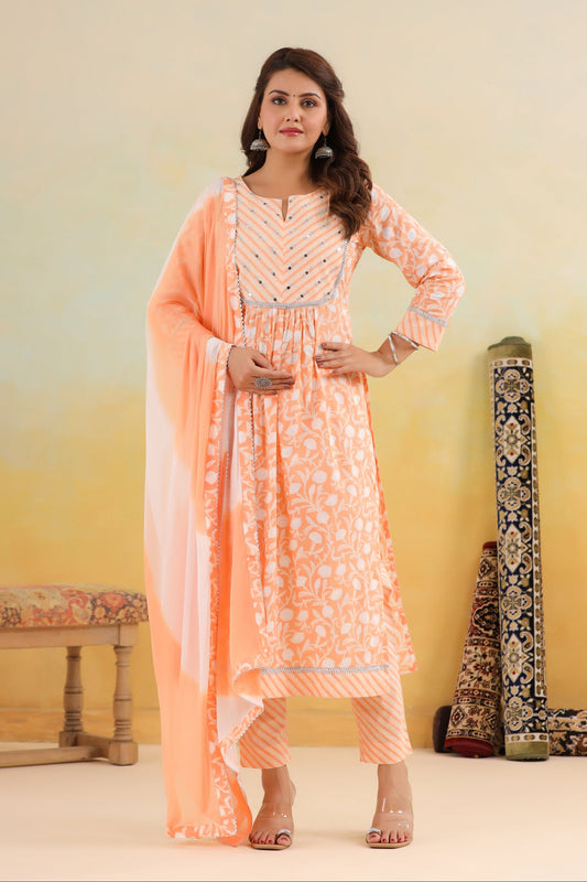 Woman in peach traditional outfit with a light pink dupatta against a gradient background