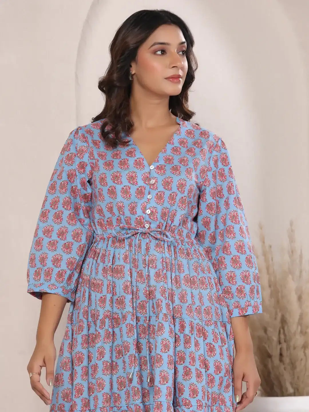 Blue cotton kurta with red floral print, V-neck, buttons, and tie waist for women's daily or festive wear