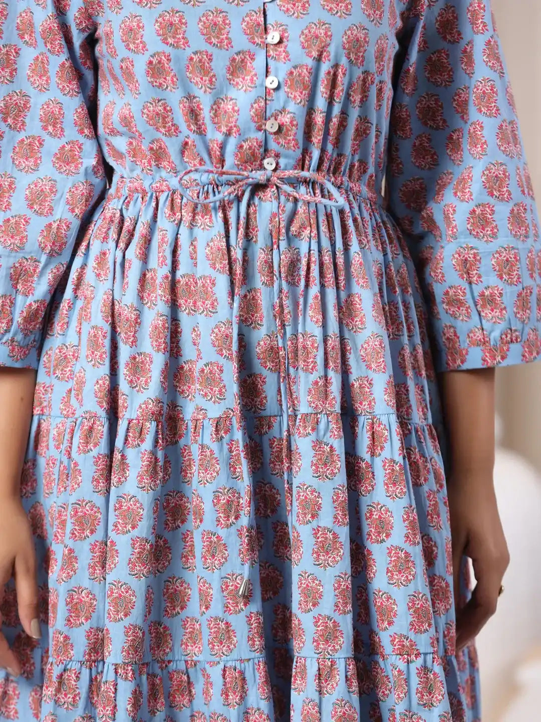 Blue cotton kurta with red floral print, tiered skirt, and drawstring waist for women