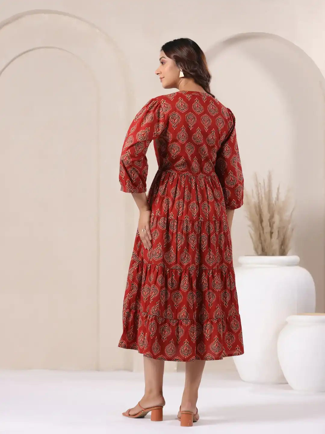 Red printed cotton kurta with tiered skirt, puff sleeves, and elegant back view for women