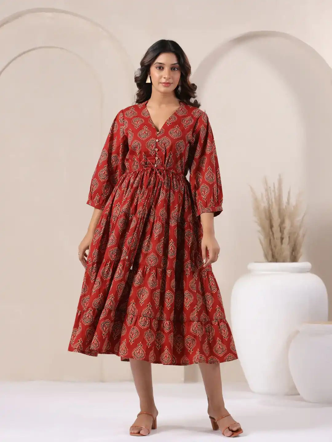 Red cotton kurta dress with paisley print, tiered skirt, and V-neck for women's daily or festive wear