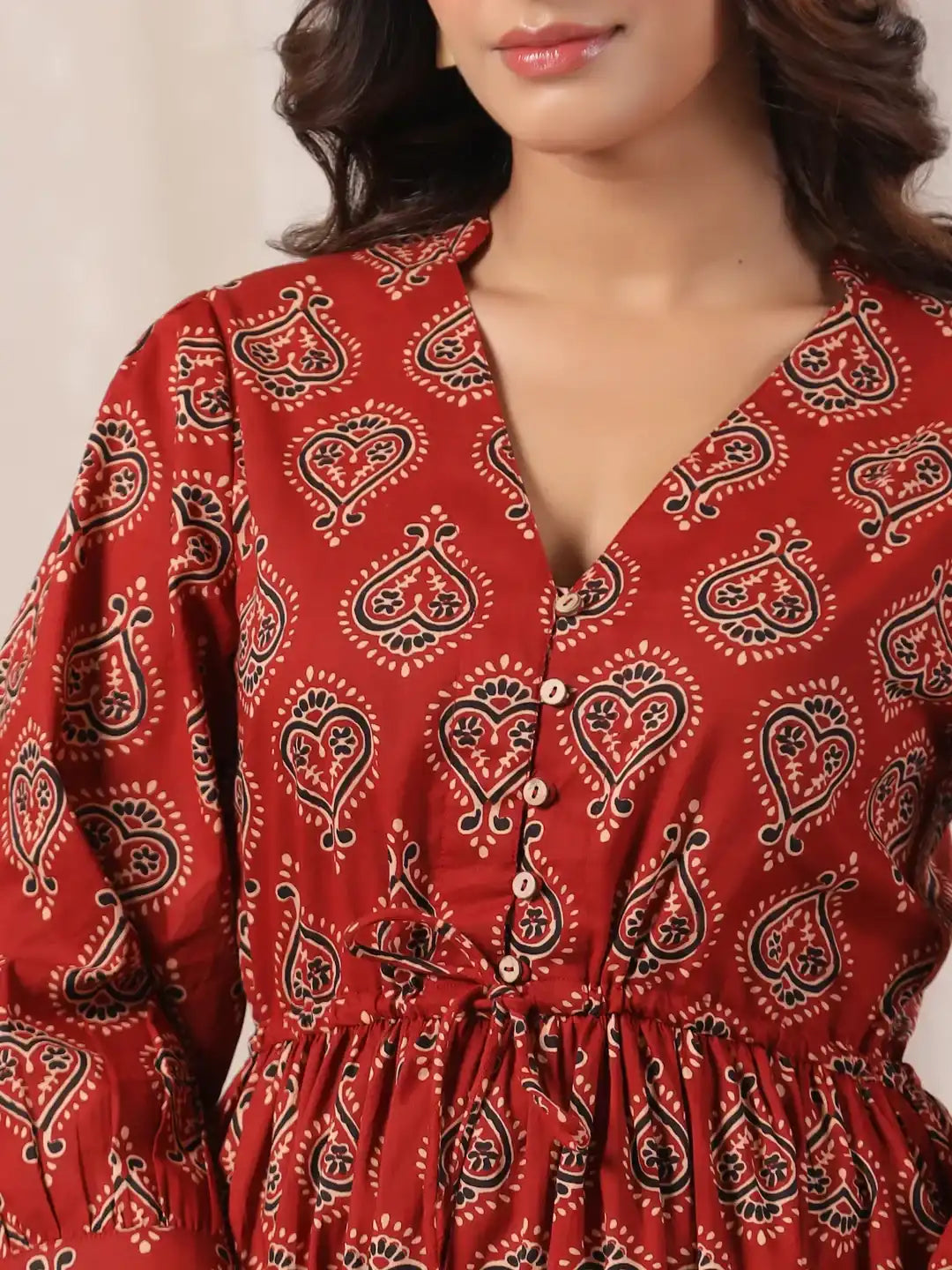 Red cotton kurta with black and white paisley print, V-neck and button front for women