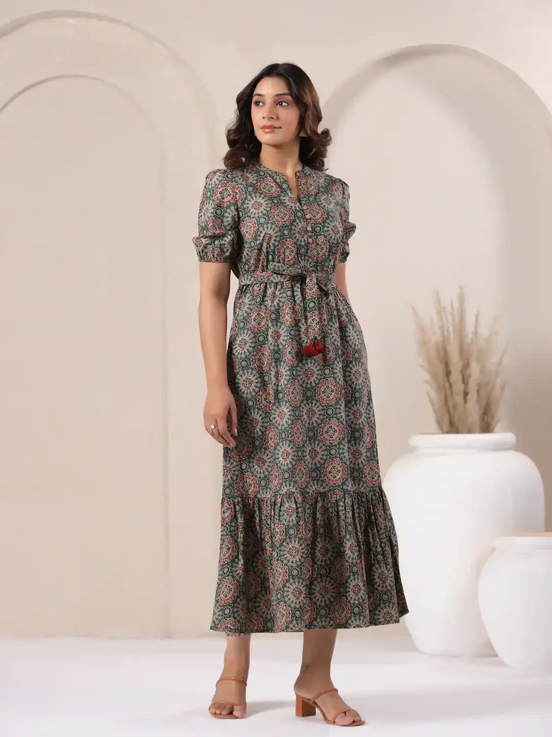 Woman in floral print cotton kurta dress with tiered hem and tie waist, perfect for daily wear or office