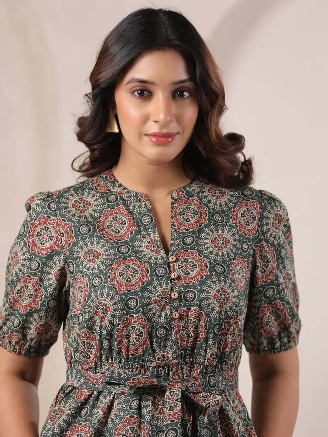 Woman in green floral print cotton kurta with puff sleeves and tie waist, perfect for daily wear or office
