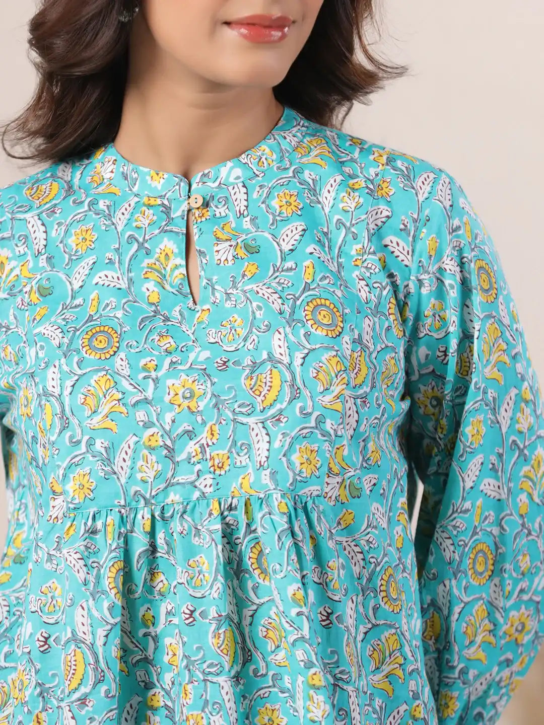 Turquoise cotton kurta with yellow floral print, round neck, and front slit for women