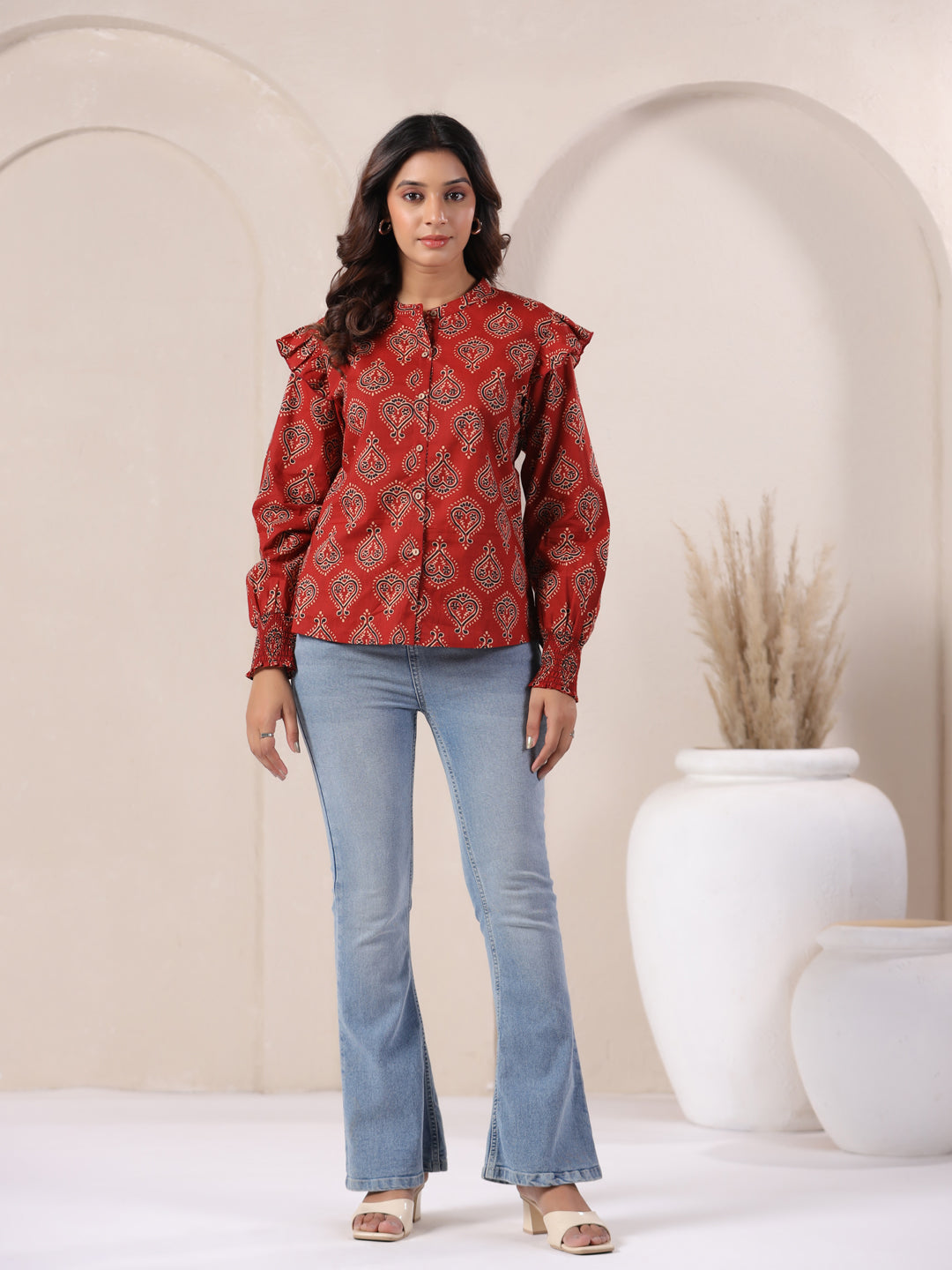 Red printed cotton kurta with ruffle sleeves paired with blue flared jeans for women