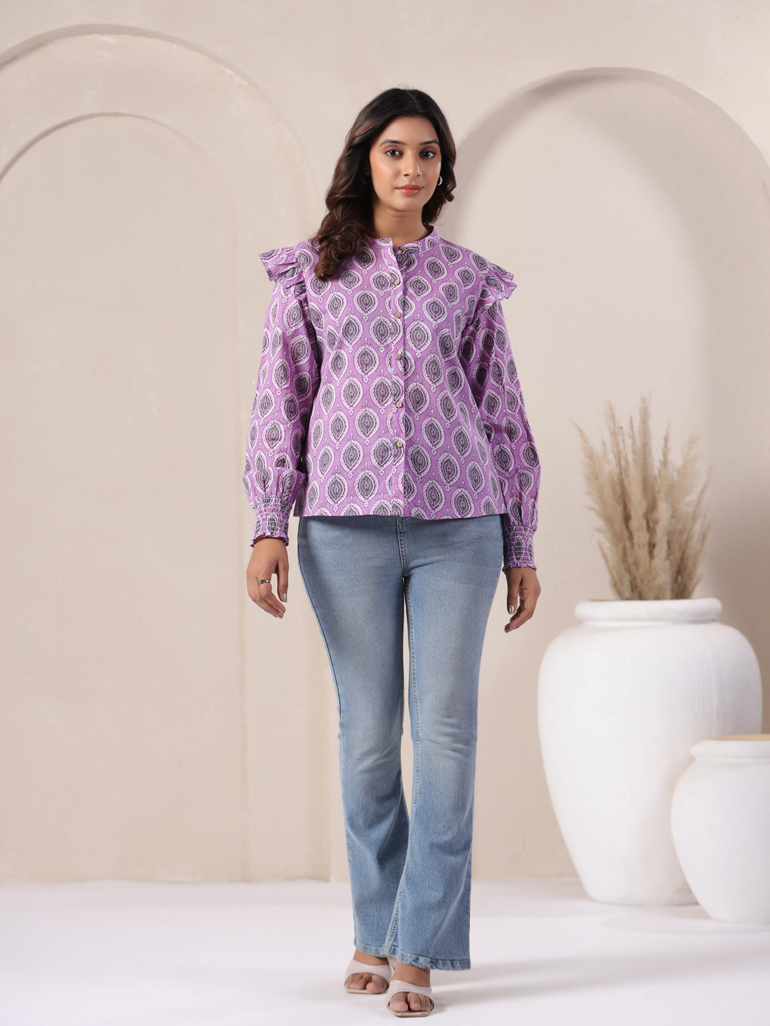 Purple printed cotton kurta with ruffle sleeves paired with blue jeans, ideal for casual or office wear.