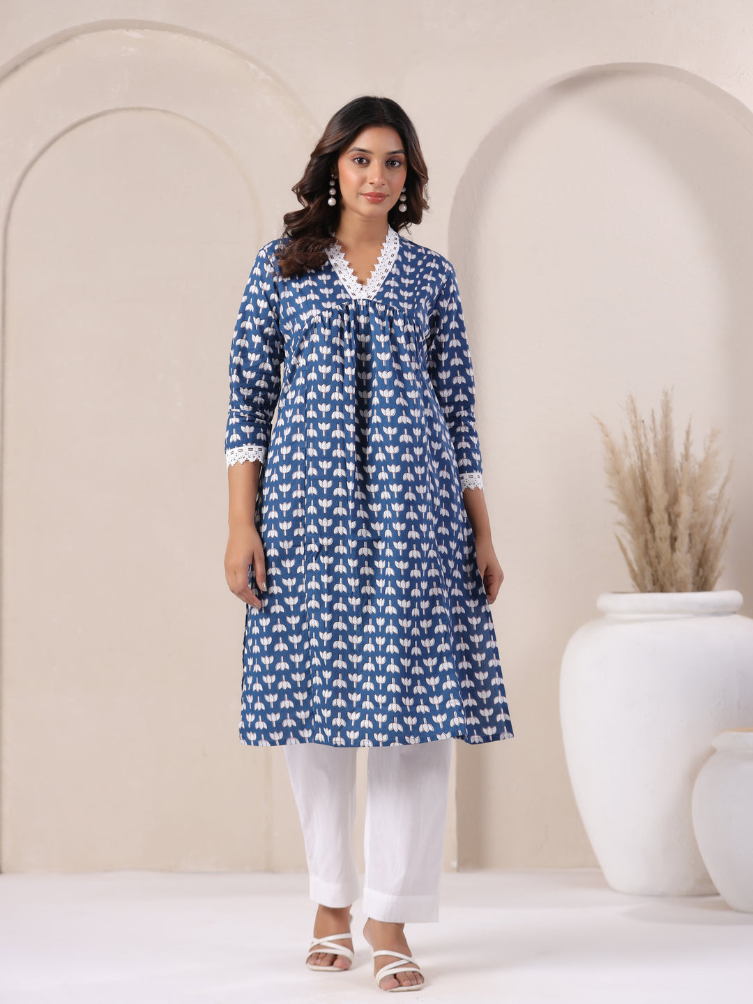 Blue floral printed cotton kurta with white lace detailing, paired with white pants for elegant daily wear