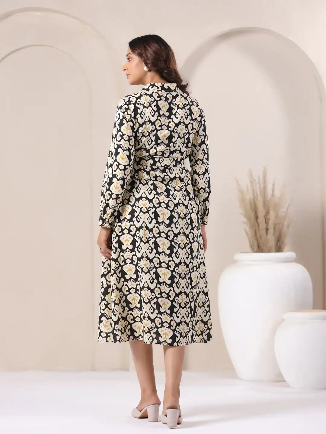 Woman in black and white printed cotton kurta with gold accents, elegant daily wear style