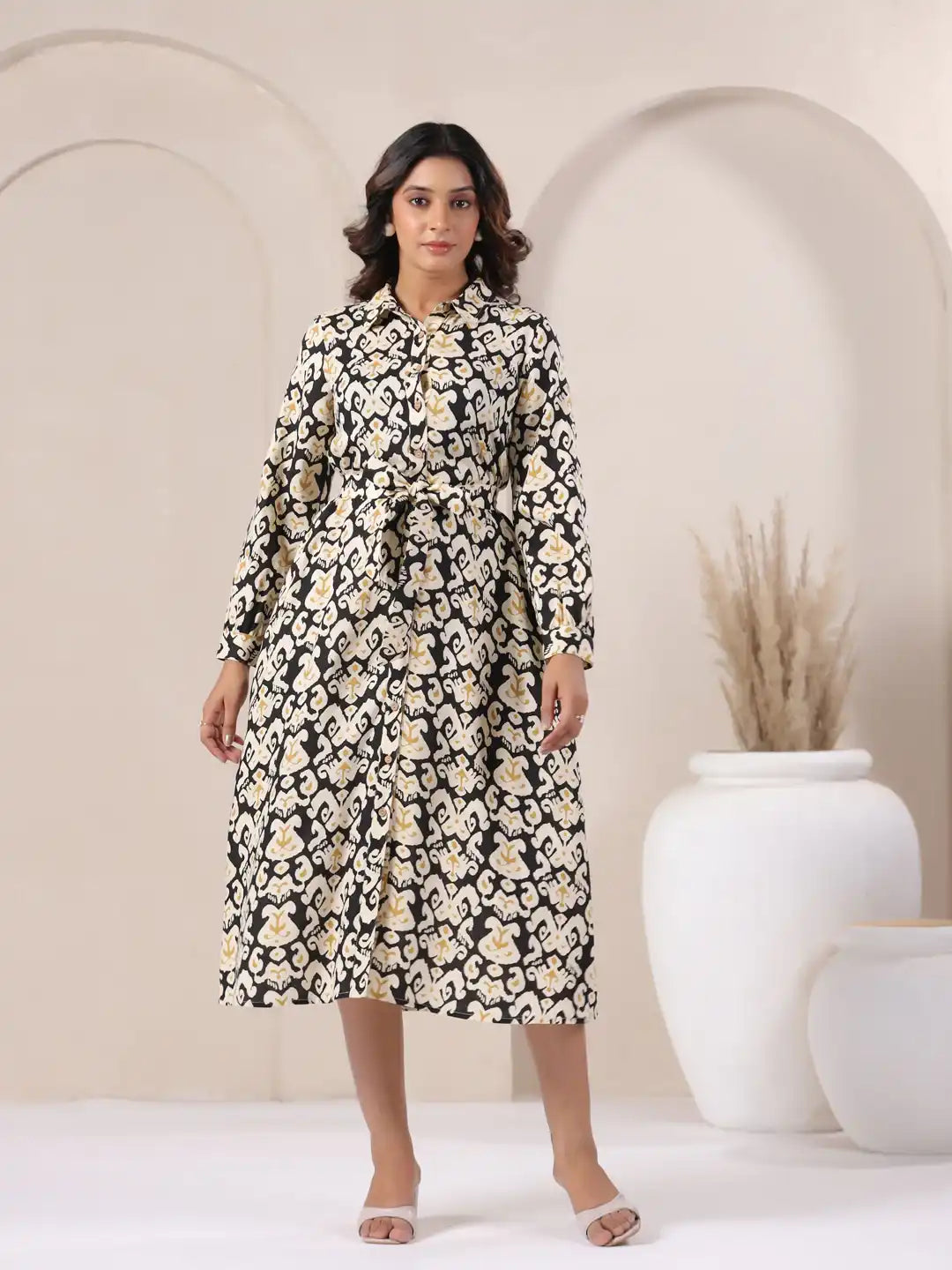 Woman wearing black and cream printed cotton kurta with tie waist, ideal for office or casual wear