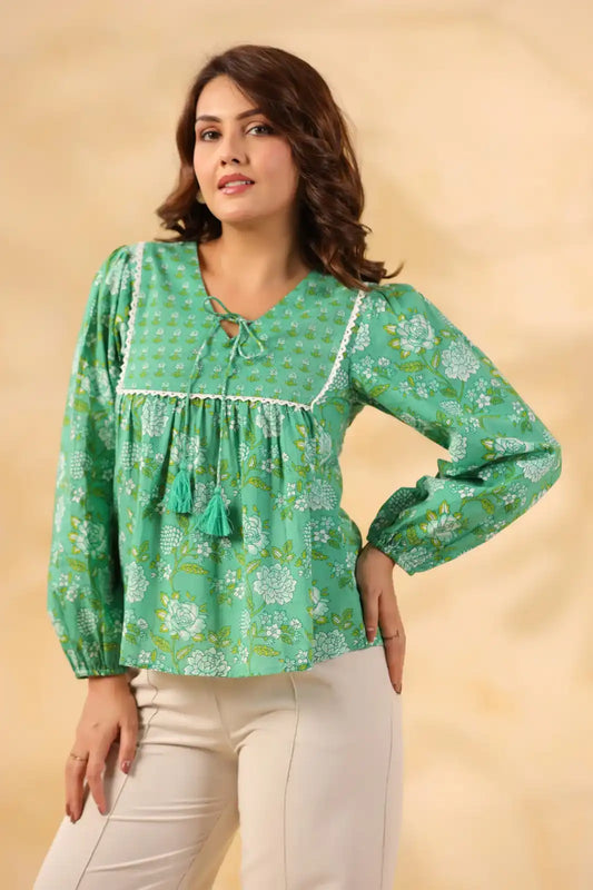 Green floral print kurta with lace trim and tassels, paired with white pants for women's casual wear