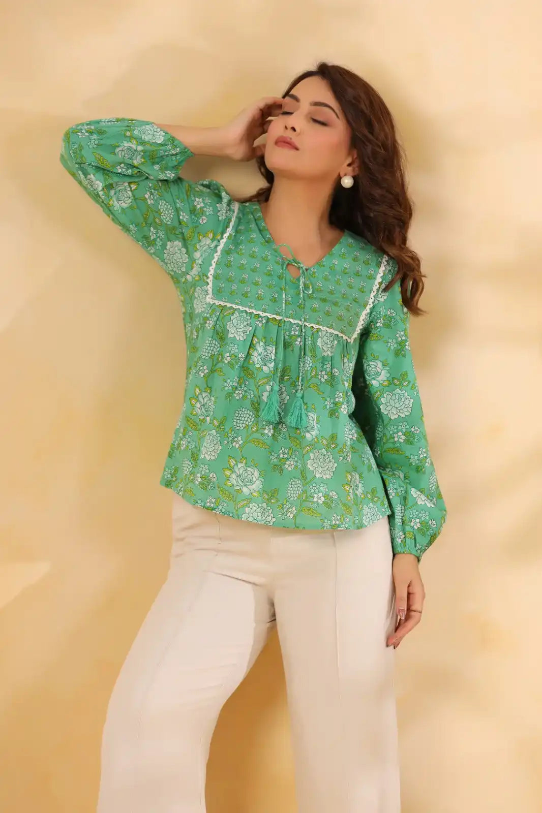 Green floral print cotton top with tassel tie, paired with white pants for casual or office wear