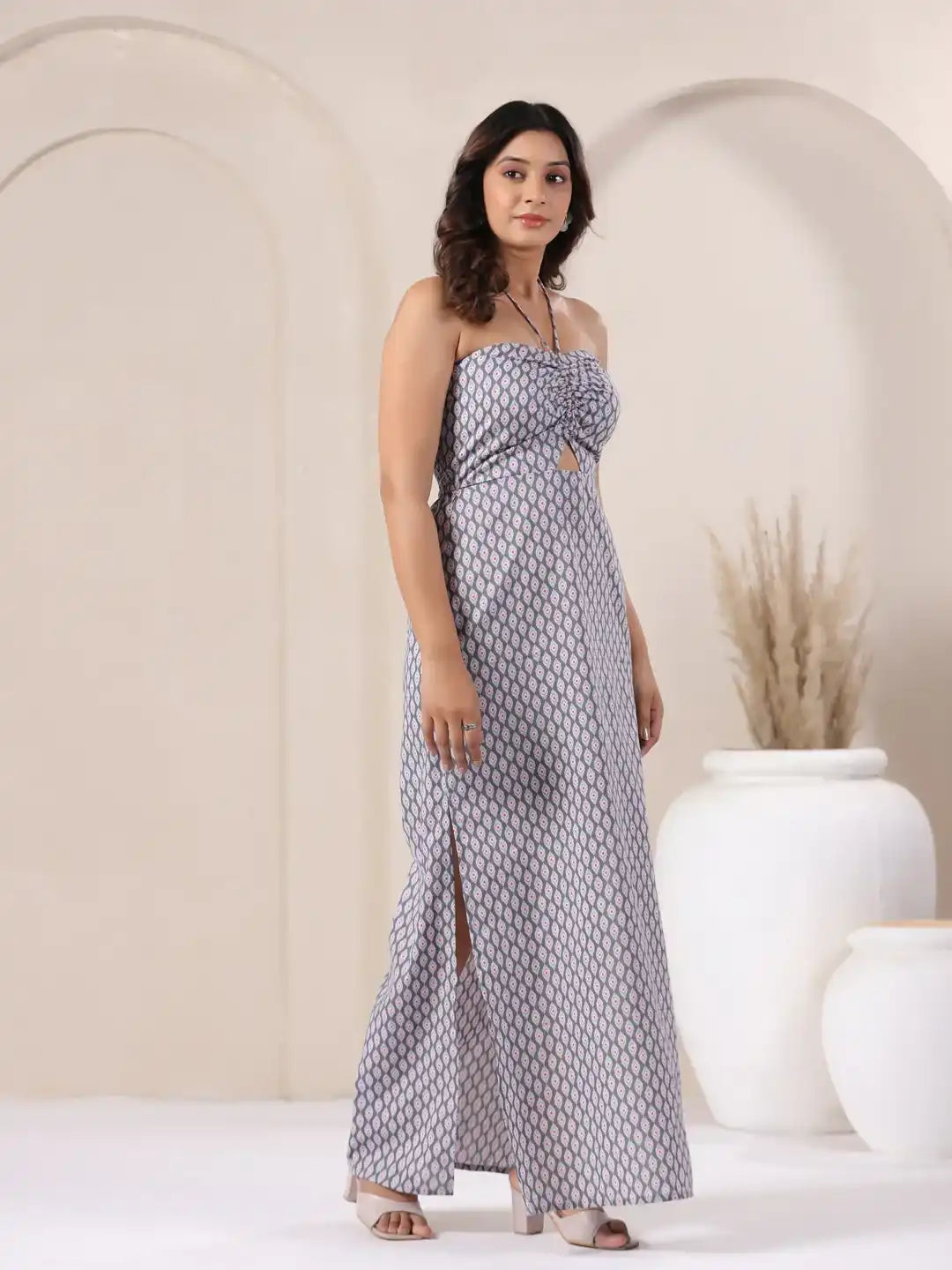 Woman in grey printed strapless jumpsuit with side slit, elegant for daily wear or celebrations