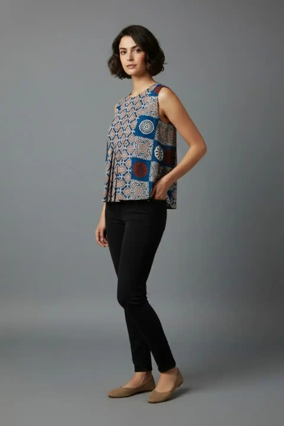 Woman wearing sleeveless printed cotton top with black pants, stylish everyday wear