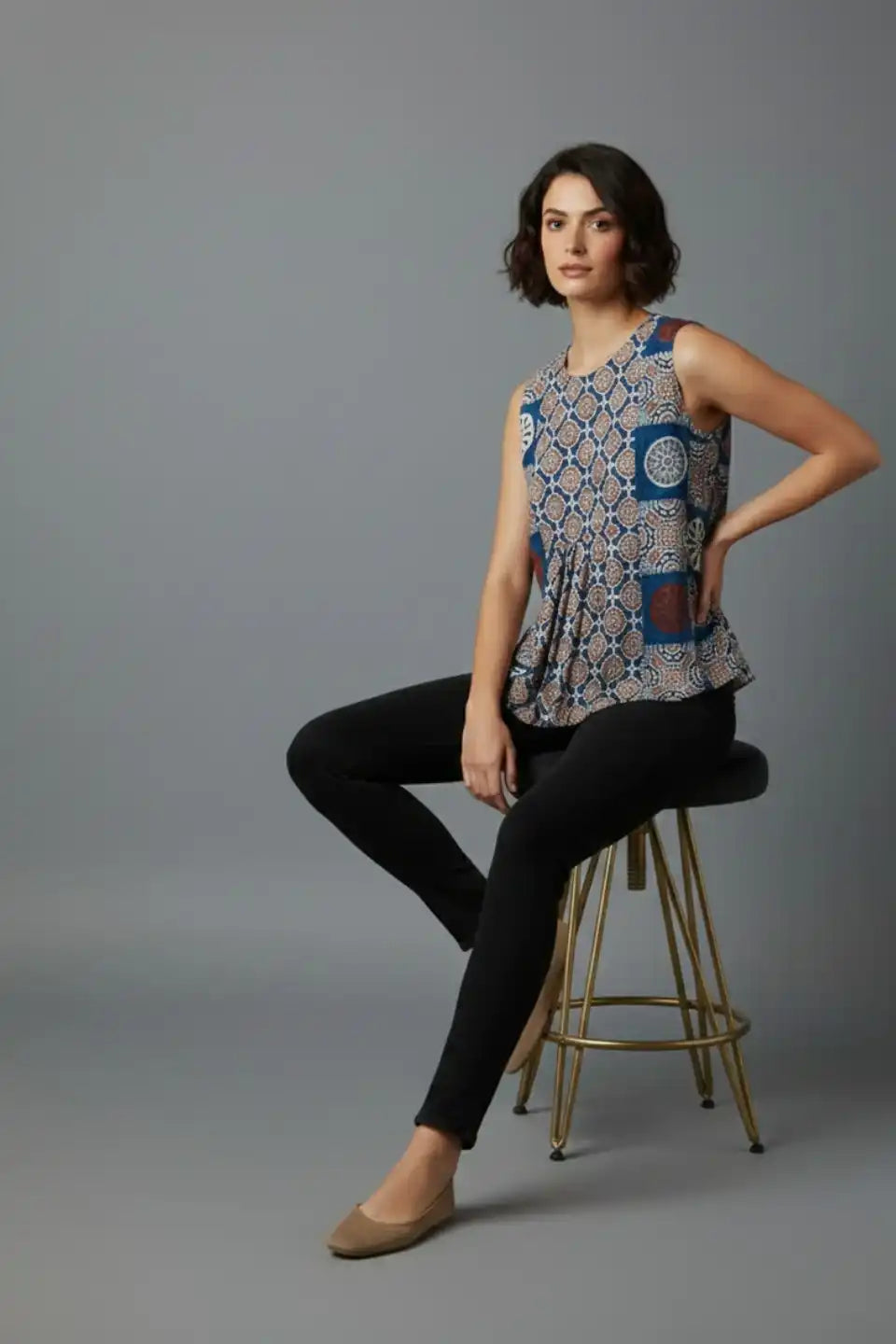 Woman wearing printed sleeveless top with black pants, stylish daily wear outfit