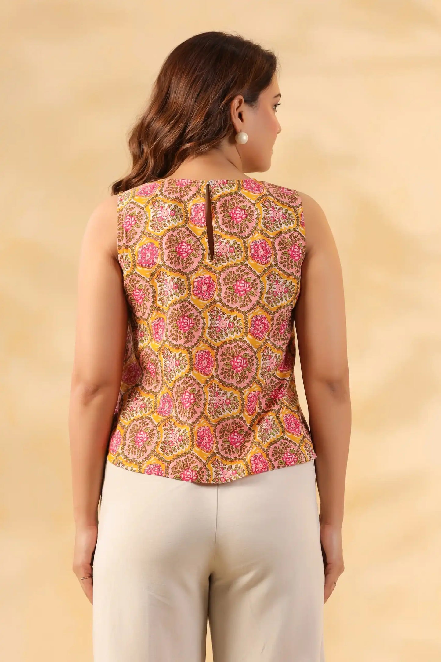 Floral print sleeveless kurta top with back slit, paired with white pants for elegant daily wear