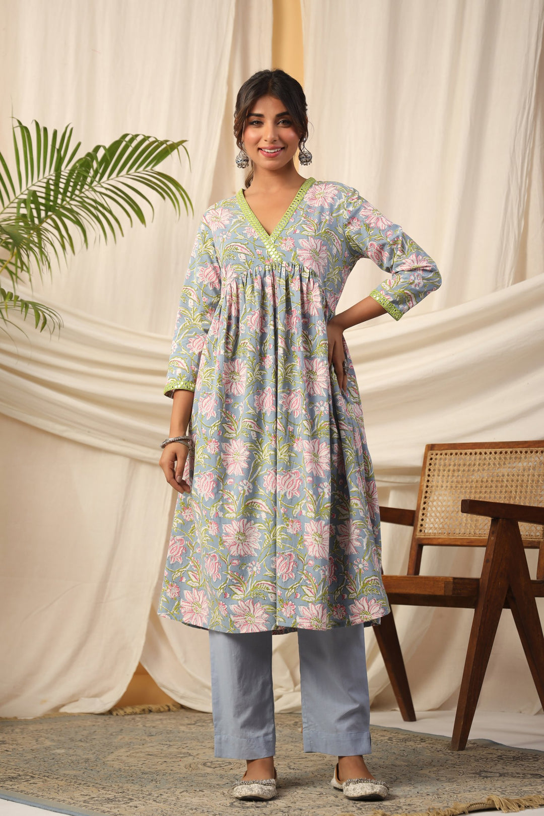 Floral print cotton kurta set with V-neck and green trim, paired with matching pants for women