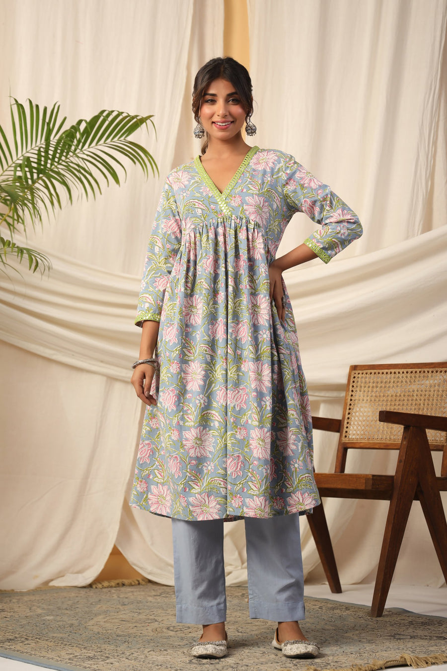 Floral print cotton kurta set with V-neck and green trim, paired with matching pants for women