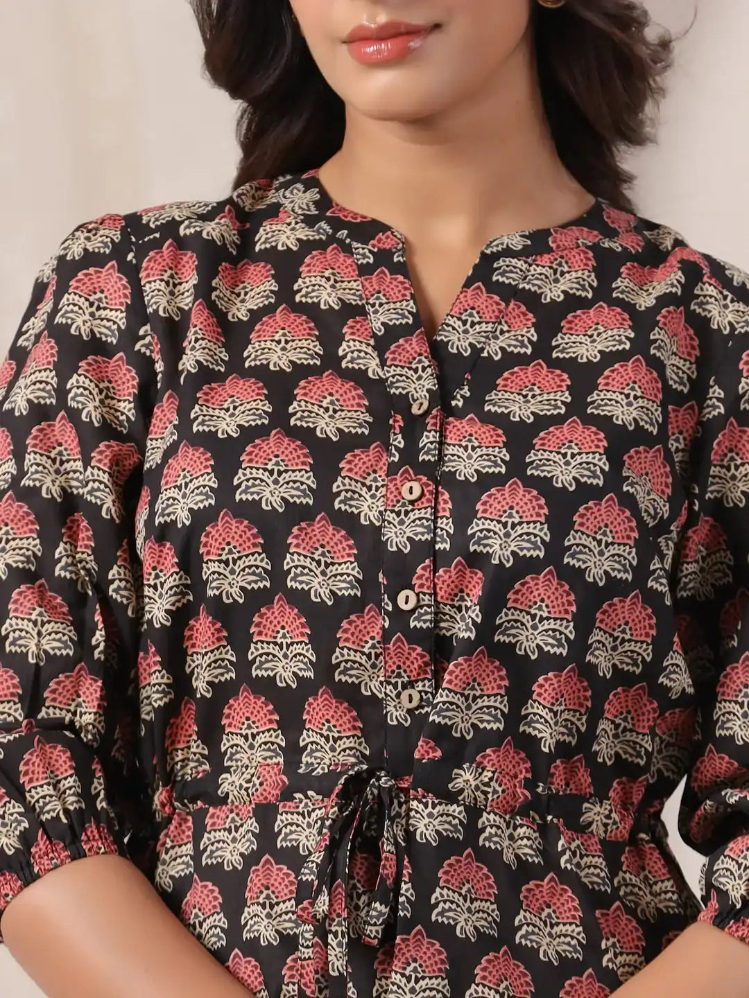 Black cotton kurta with red and cream floral print, button front, and drawstring waist for women