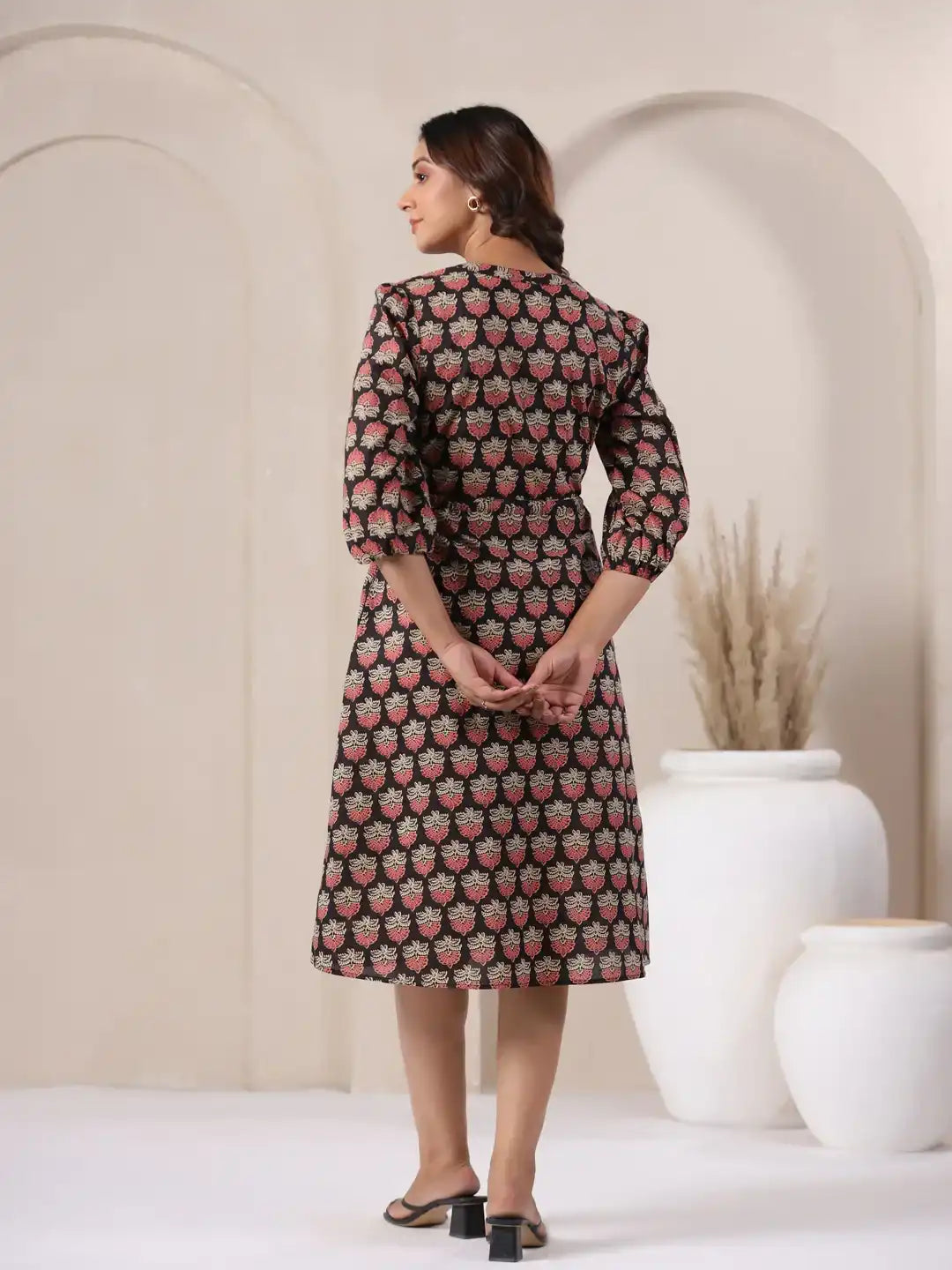 Woman wearing floral print cotton kurta dress with puff sleeves, elegant for daily or office wear