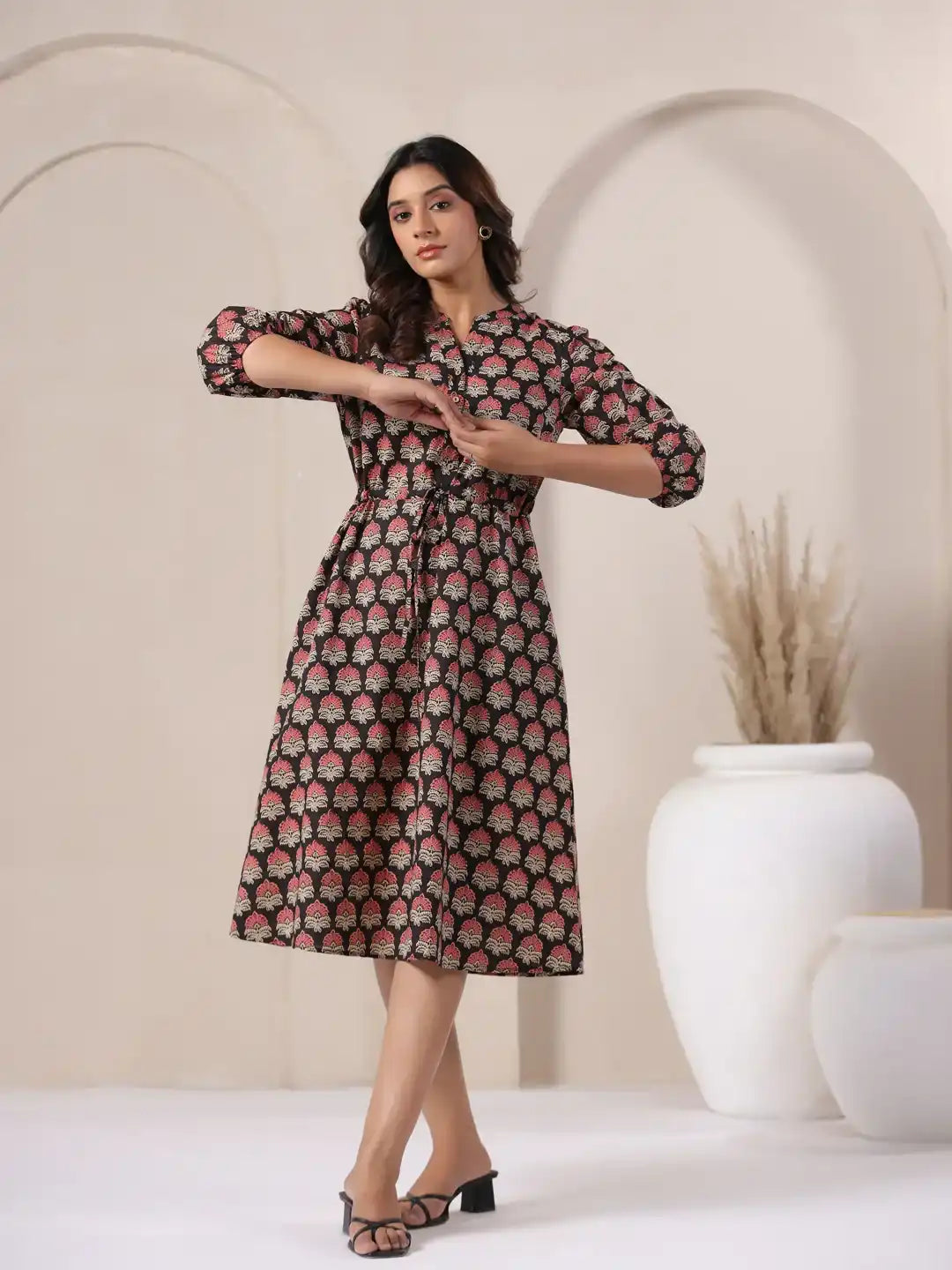 Woman in black cotton kurta dress with pink floral print, elegant daily wear style