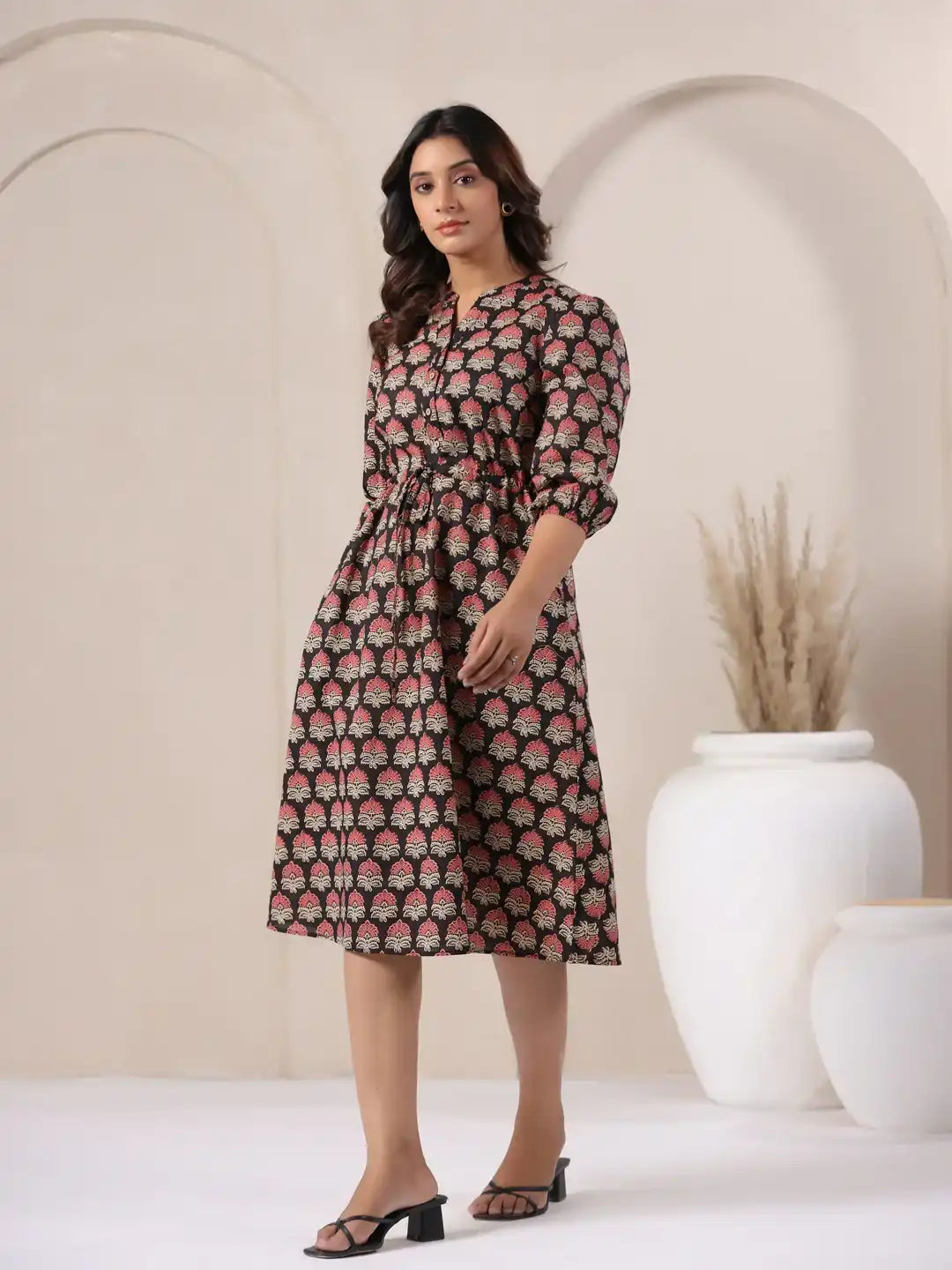 Woman in floral print cotton kurta dress, elegant daily wear style with tie waist and 3/4 sleeves