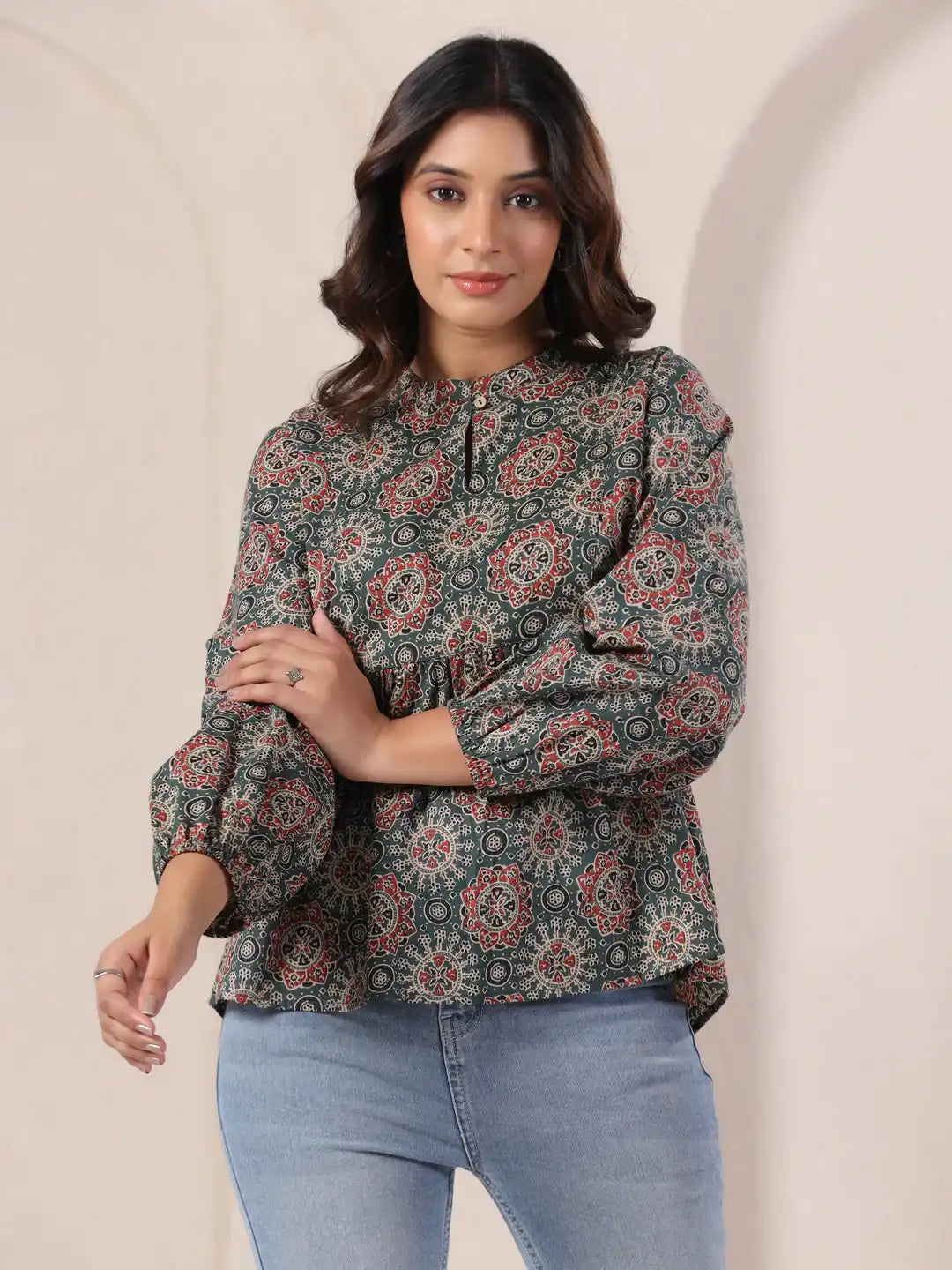 Woman wearing green printed cotton kurta with puff sleeves, paired with jeans for casual wear