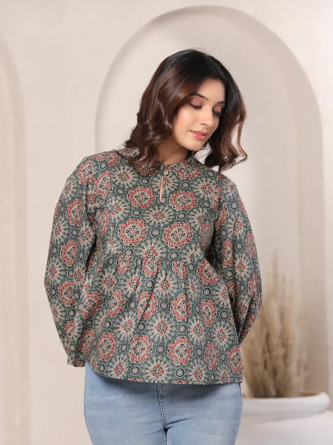 Woman wearing printed cotton kurta with floral pattern, paired with jeans for casual daily wear